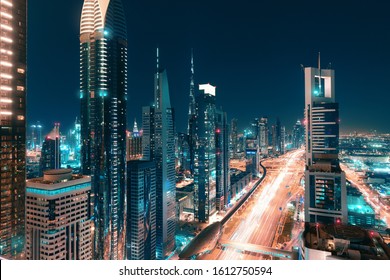 Night View Of The Spectacular Landscape Of Dubai With High-rises And Skyscrapers At The Sheikh Zayed Highway. Global Travel Destinations And Real Estate Concept