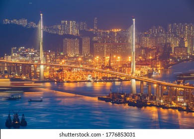 Night view from Victoria Peak  with illuminated buildings at twilight.Stonecutters highway bridge Victoria harbour view in Hong Kong.