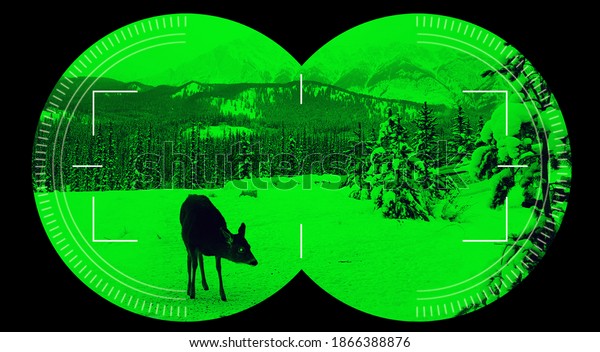 Night vision view with binocular\
scope in green of deer in the snow with dark mountain\
background