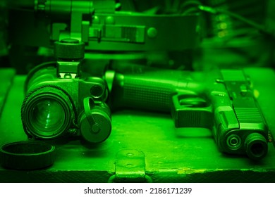 Night Vision View.  Pistol And Night Vision Device Close-up.