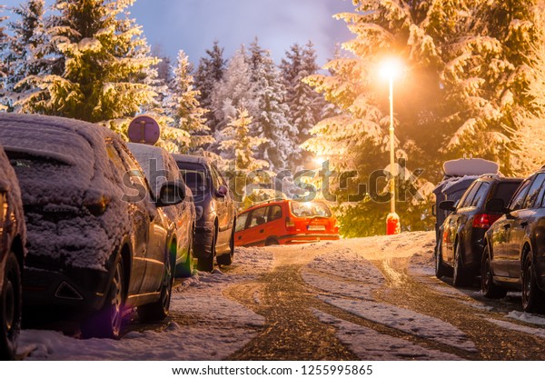 Night winter street with\
parked cars