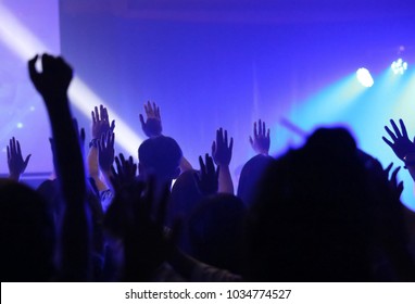 Night of worship. Silhouette people worship. Christian music concert with raised hand. Christianity concept. 