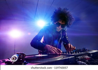 Nightclub Dj Playing Music On Deck With Vinyl Record Headphones Light Flare Clubbing Party Scene