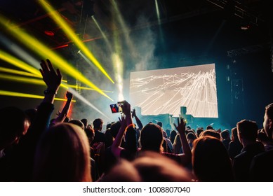 Nightclub Dj Rave Party With Crowd Of People Hands Up