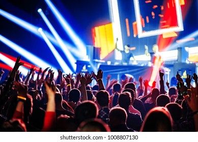 Nightclub Dj Rave Party With Crowd Of People Hands Up