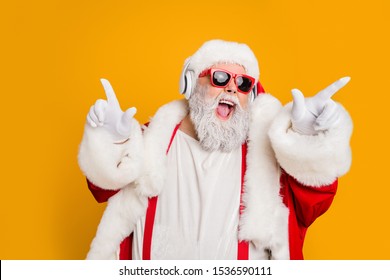 Nightclub invite on christmas party celebration funky crazy santa claus dj in white headset sing song sound melody listen music dance wear stylish x-mas hat suspenders isolated yellow color background - Powered by Shutterstock