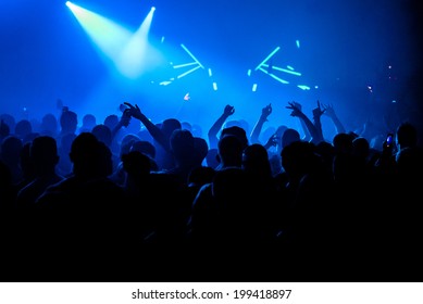 Nightclub party crowd with hands in the air