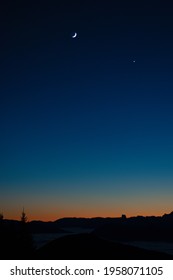 Nightfall on the mountainous horizon one winter evening - Shutterstock ID 1958071105