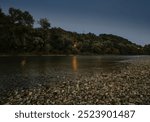 Nightfall over Sava river shore near the town of Zapresic, Croatia, with northern bank covered in dense trees, popular place for sport fishing