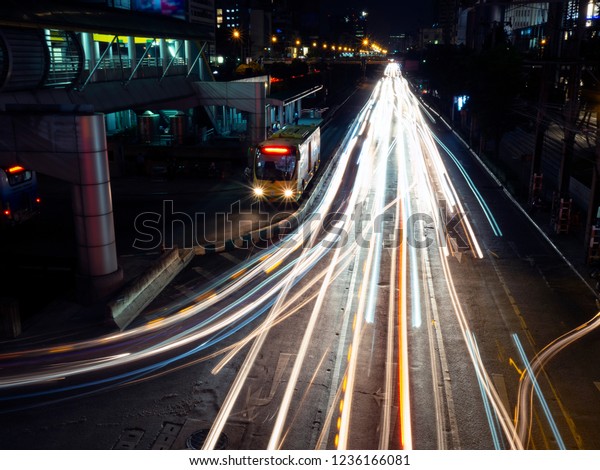 Nightlife in the city, speed light on the\
road, night scene at downtown. Street light in the dark. Travel\
destination in asia, car\
transportation.