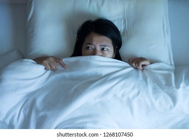 Nightmare Or Bad Dream,Asian Woman With Scare And Panic While Lying Down Under The Blanket In Bedroom