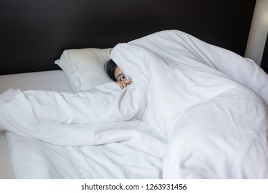 Nightmare Or Bad Dream,Woman Scared And Peeking From Blanket In Bedroom