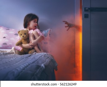 Nightmare For Children. Little Child Girl Is Afraid Of Monsters In The Dark Of Night.