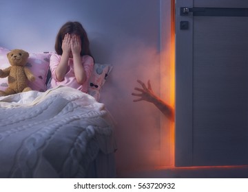 Nightmare For Children. Little Child Girl Is Afraid Of Monsters In The Dark Of Night.