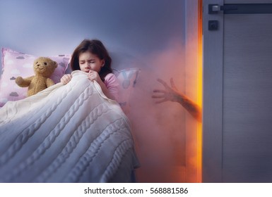 Nightmare For Children. Little Child Girl Is Afraid Of Monsters In The Dark Of Night.