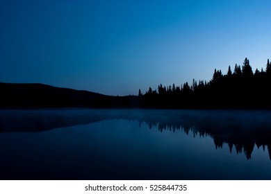 Nighttime Landscape With Reflection On A Lake