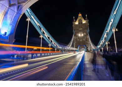 Nighttime long-exposure shot of Tower Bridge in London, featuring vibrant light trails and illuminated architecture - Powered by Shutterstock