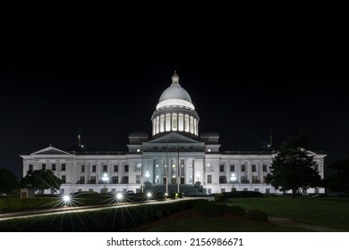 A nighttime view of The Arkansas State Capitol illuminated by lights