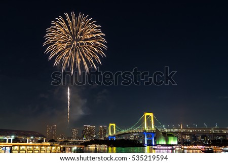 Nightview of Rainbow Bridge and fireworks in Tokyo, Japan.