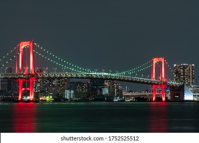 Nightview of Rainbow Bridge, illuminated in red as a sign of 