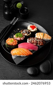 Nigiri composition on black background. The Art of Japanese Cuisine. Food photography for menu and sushi bar decoration