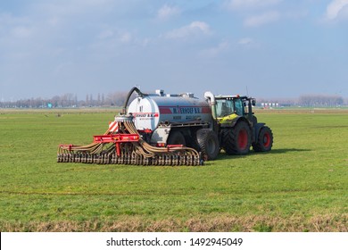 NIJKERK, NETHERLANDS - MARCH 2, 2019: Tractor with liquid manure injector fertilizing a meadow