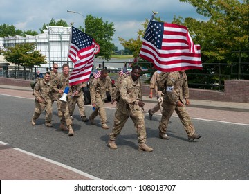 NIJMEGEN, NETHERLANDS - JULY 18: American Soldiers Marching On July 18, 2012 In Nijmegen, Netherlands. It Is The World's Largest Walking Event With Over 40,000 Participants.