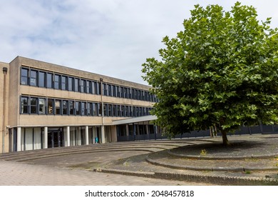 Nijverdal, The Netherlands - August 13, 2021: Playground Square With Solitary Tree In Next To Reggesteyn Secondary Education Exterior School Building