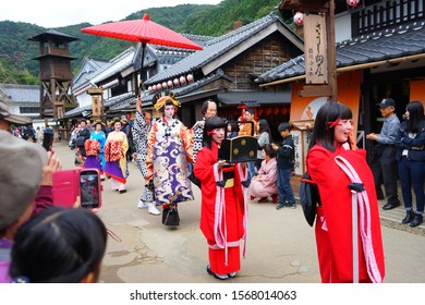Nikko, Japan - Oct. 28, 2019: Elegant oiran courtesans parade through the streets of Edo with their full entourage. Oiran means the highest rank of courtesan.