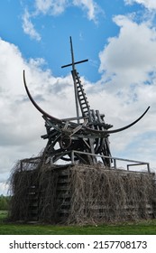 Nikola-Lenivets, KALUGA REGION, Russia - 15 May, 2022. Ugra National Park, Park Of Modern Art Objects In Nature. Green Clearing And Cloudy Sky. Sculpture Wooden Gilded Taurus.