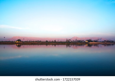 Nile River At Sunrise With Hot Air Balloons In Luxor, Egypt.