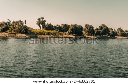 Nile valley natural landscape view from water on river bank,  
Travel Egypt Nile cruise