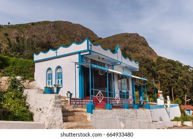 Nilgiri Hills, India - October 26, 2013: Small, Sober, Blue And White Catholic Church Feature Statues Of Jesus And Angels. Highland Background.