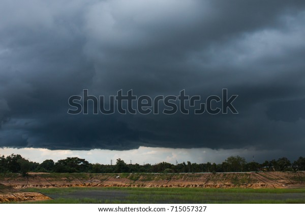 nimbostratus clouds /it was beginning to rain\
above the pool/ countryside of\
Thailand