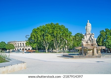 Nimes, city in Southern France, Gard, Occitanie, Pradier fountain and Arena of Nîmes, Roman amphitheatre on summer day