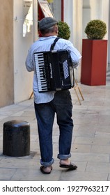 Nimes, France 2012. Accordian Player Walking Through The Quiet Streets.