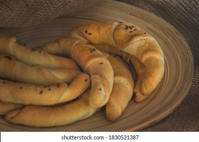 Nine freshly baked baguette-like rolls sprinkled with flax seeds and salt. This type of pastry is very popular in Eastern Europe.