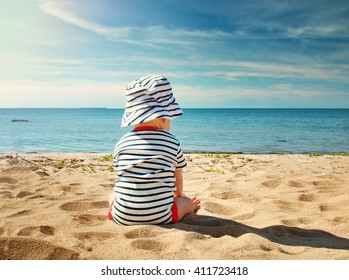 Nine Month Old Baby Boy Sitting On The Beach In Beautiful Summer Day