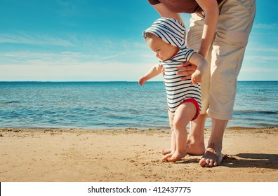 Nine Month Old Baby Boy Walking On The Beach In Beautiful Summer Day