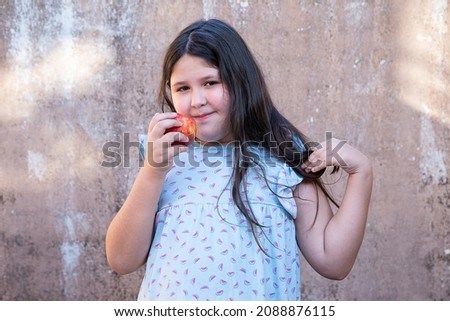 nine year old girl enjoys a fresh apple