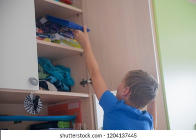 A Nine Years Old Boy Organizing His Messy Bedroom