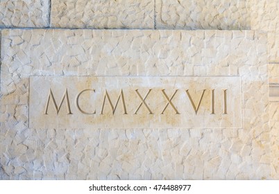 Nineteen Twenty Seven In Roman Numerals On Stone