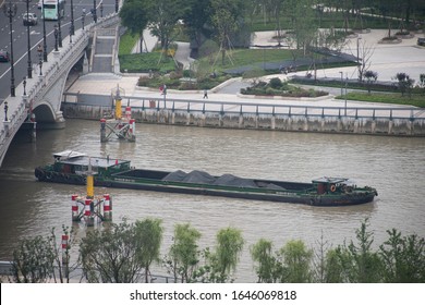 Ningbo, China. 10062018. Port City Of 7 Million With State-planning Status Ningbo Offers Vibrant Mixture Of Rich History And Blooming Present. A Coal Barge On The Yong River Floats To A Power Plant.