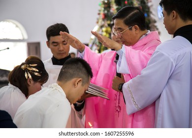 Ninh Binh, Vietnam - Vietnamese Parish Priest Conducting A Baptism Ceremony For An Adult In A Church.