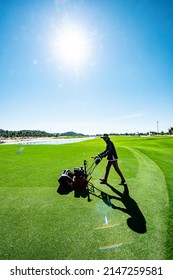 Ninh Thuan, Vietnam - July 21 2021: Workers Apply Fertilizer To The Turf Of A Golf Course And Mowing The Grass - Golf Course Maintenance