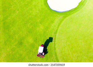 Ninh Thuan, Vietnam - July 21 2021: Workers Apply Fertilizer To The Turf Of A Golf Course And Mowing The Grass - Golf Course Maintenance