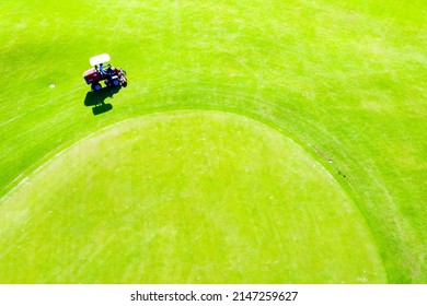 Ninh Thuan, Vietnam - July 21 2021: Workers Apply Fertilizer To The Turf Of A Golf Course And Mowing The Grass - Golf Course Maintenance