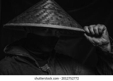 Ninja In Hat Posing Over Dark Background