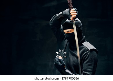 Ninja samurai warrior fighter with a sword and shuriken over black background. japanese fighter concept
