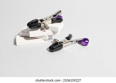 Nipple clamps from sex shop on light background
